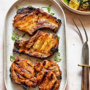Top down shot of grilled teriyaki pork chops on a serving platter