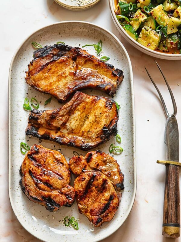 Top down shot of grilled teriyaki pork chops on a serving platter
