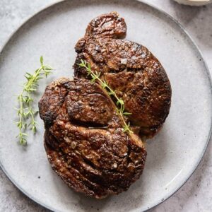 top down view of a piece of steak on a plate