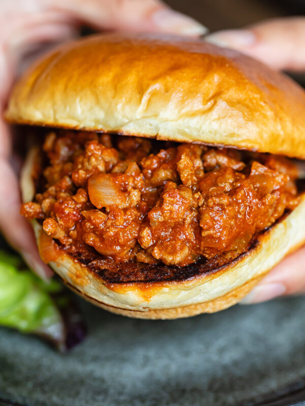 Close up shot of someone holding a sloppy joe