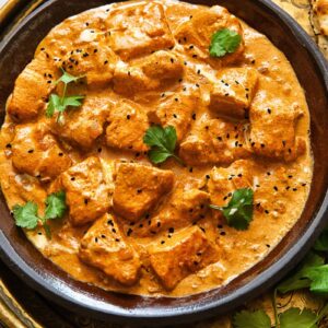 Top down shot of butter salmon chicken on a plate