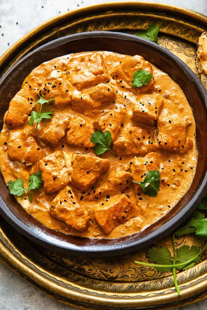 Top down shot of butter salmon chicken on a plate