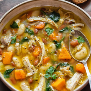 Top down shot of chicken and bean soup in a bowl