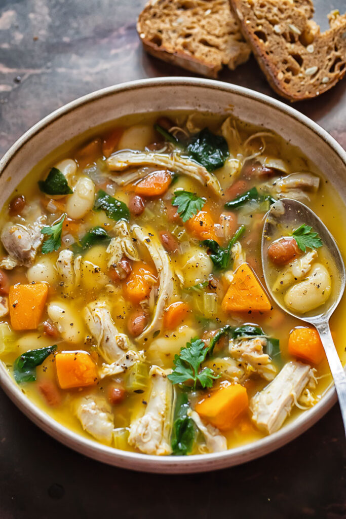 top down shot of chicken and bean soup in a bowl