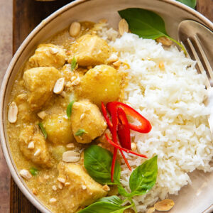 Top down shot of yellow chicken curry with rice on a plate