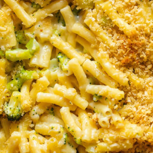 Close up shot of broccoli mac and cheese topped with breadcrumbs