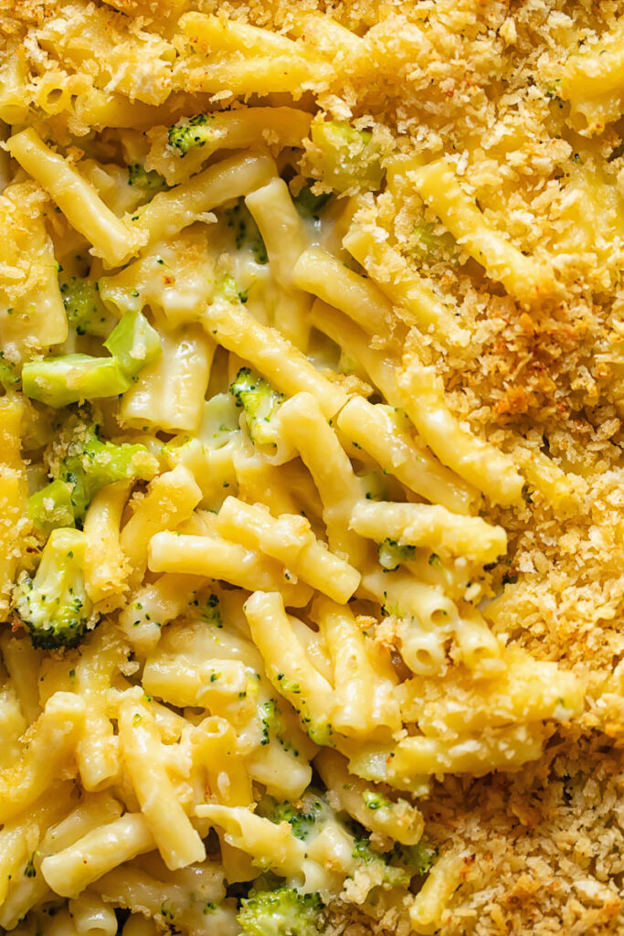 Close up shot of broccoli mac and cheese topped with breadcrumbs