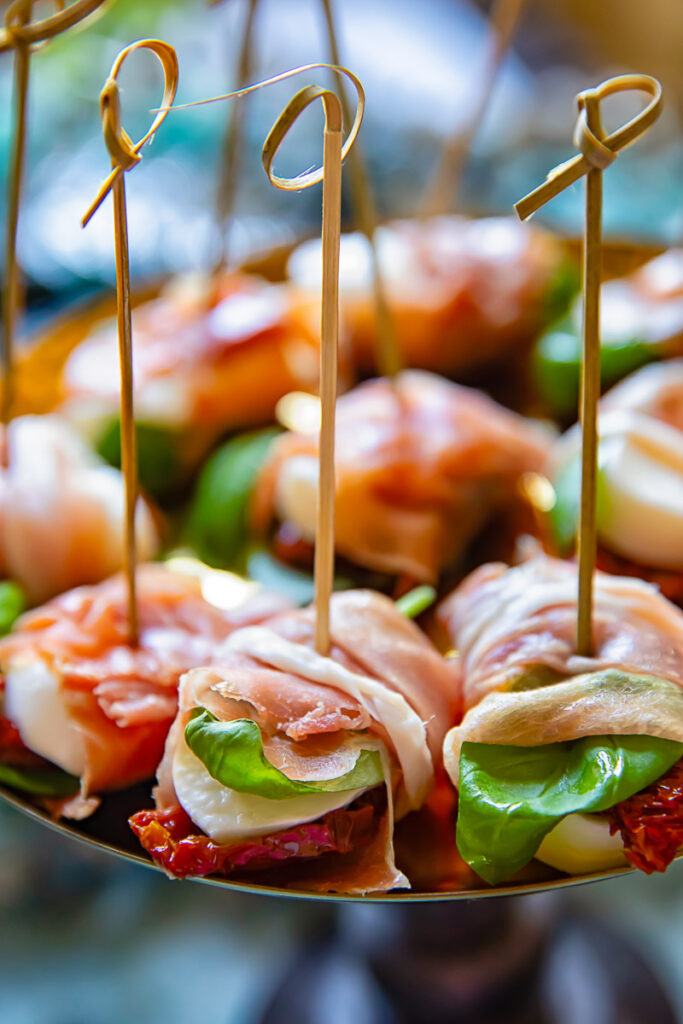 caprese bites arranged on platter with toothpicks