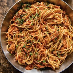 pan of pasta with flaked tuna sprinkled with chopped parsley