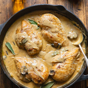 Top down shot of somerset chicken in a pan with creamy cheese sauce