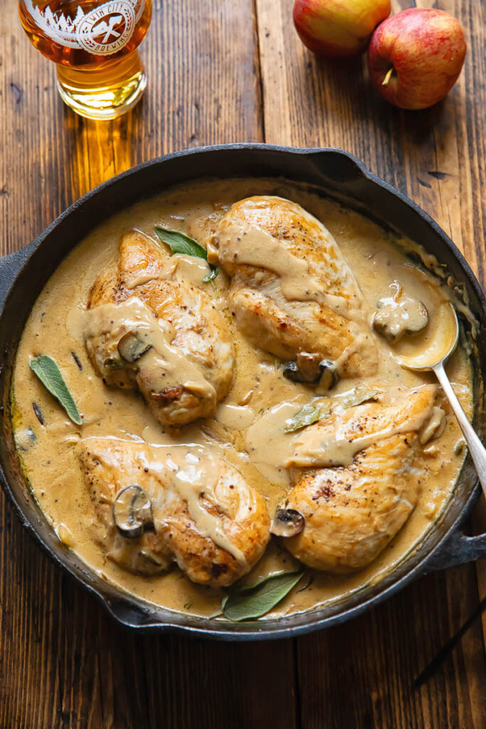 Top down shot of somerset chicken in a pan with creamy cheese sauce