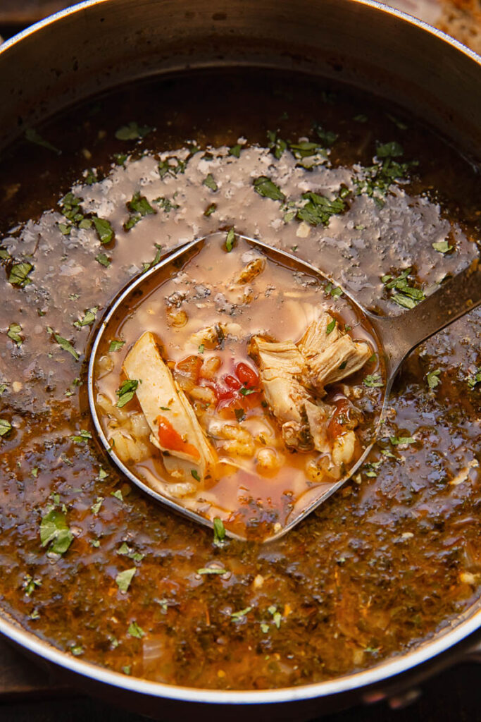 close up of chicken and rice soup in a pot