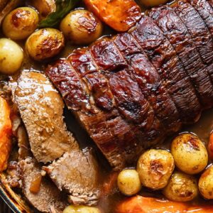 Close up of pot roast and veg in a large pot