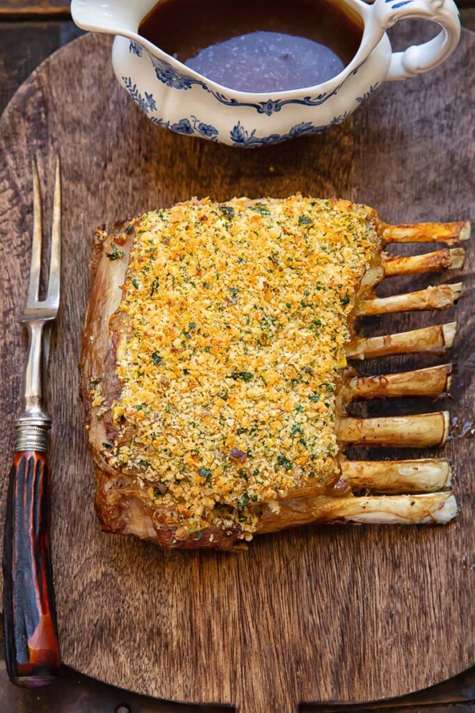 Rack of lamb roasted with breadcrumbs on a cutting board