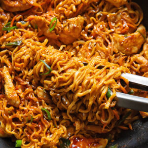 Close up shot of peanut chilli noodles in a pan