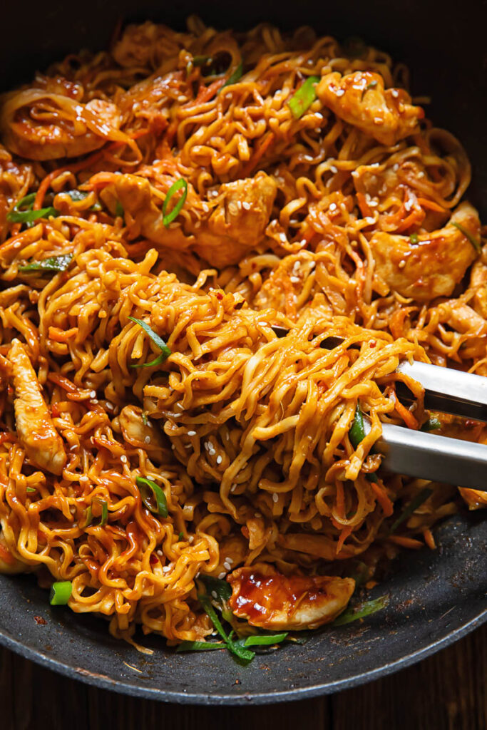 Close up shot of peanut chilli noodles in a pan
