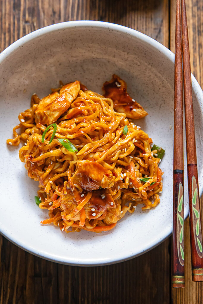 Top down of stir fry peanut chilli noodles in a bowl