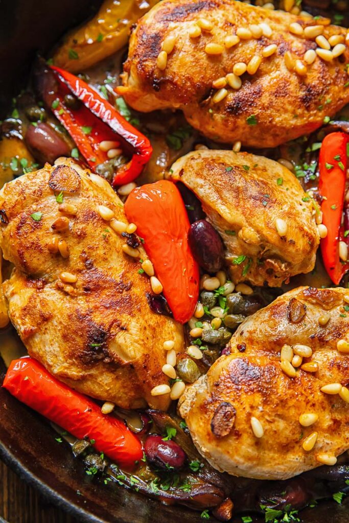 Close up of baked chicken in Mediterranean sauce