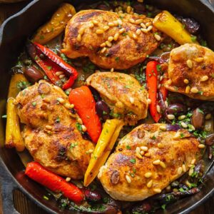 Top down shot of Mediterranean chicken in a pan with olives and peppers