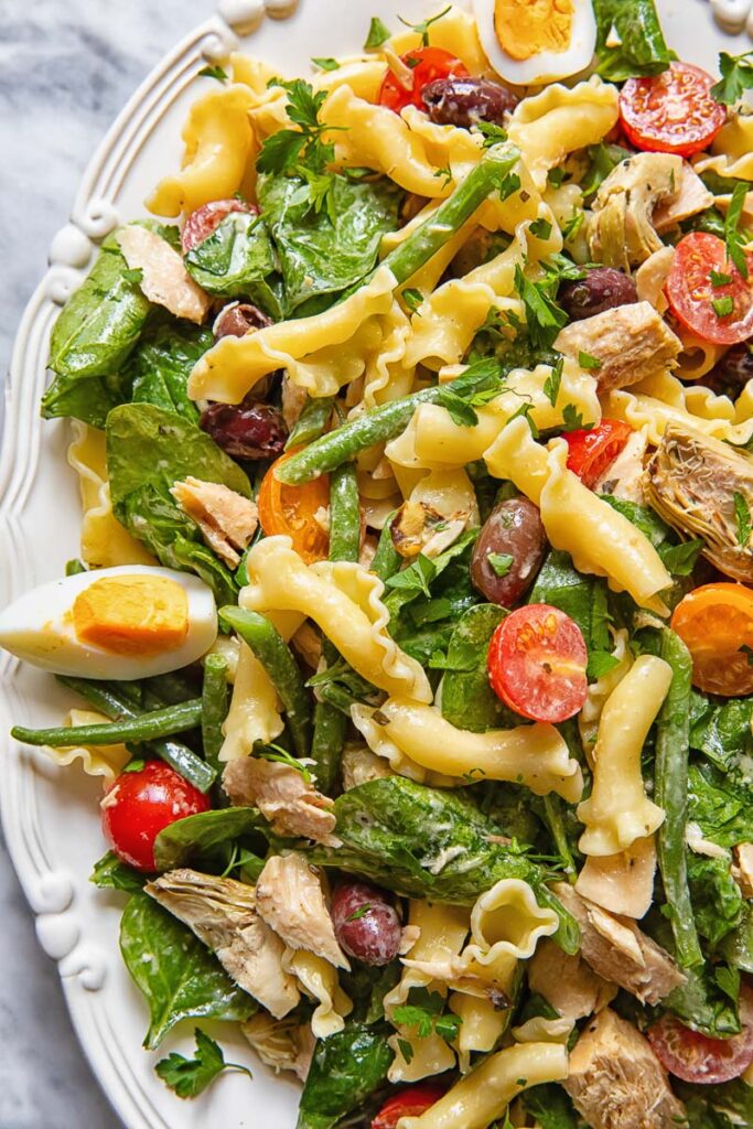 Close up of pasta salad with tuna, olives and tomatoes