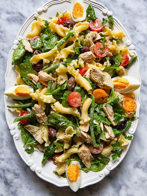 Top down shot of Nicoise pasta salad on a serving platter