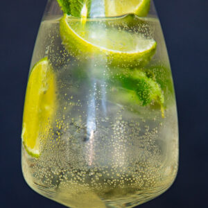 horizontal photo of white wine glass with limoncello spritz