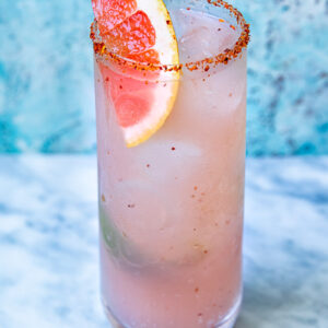 Close up shot of mezcal paloma in a tall glass