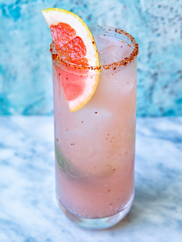 Close up shot of mezcal paloma in a tall glass