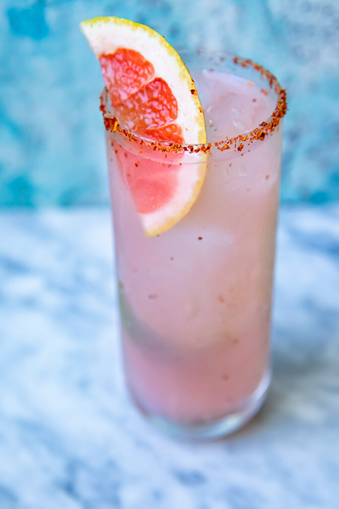Smoky mezcal paloma with a slice of grapefruit