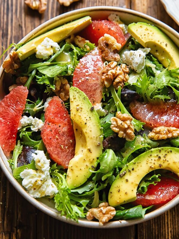 A dish of autumn salad with grapefruit, avocado and goat cheese.